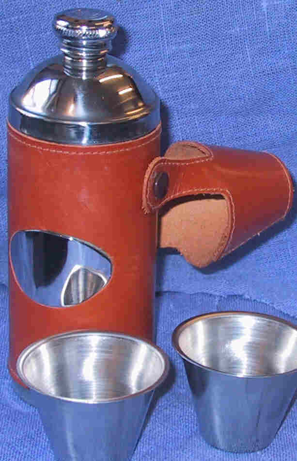 Sportsman's flask (6 oz) covered in red crocodile print leather, with cups. All flasks have a silk lined display box and filler funnel.